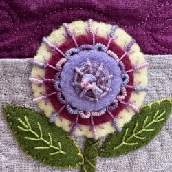 2” penny using 3 colors of wool. In addition to the whipped woven circle, I have used drizzle stitches in center, bullion knots around center circle, fly stitch which has bullion knot coming out of it.