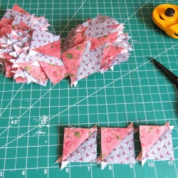 holy cow. 120 1.5 inch half square triangle blocks. Still need to trim them.