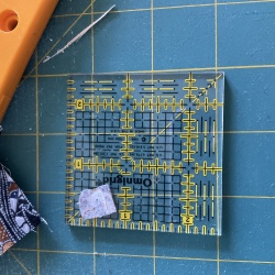 Hint - I stick a piece of carpet tape (sticky 2sides) on the back of my ruler to hold the little devils still.