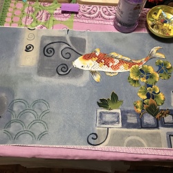 I still have to machine sew down the fish since the upholstery fabric is rejecting the misty fuse.